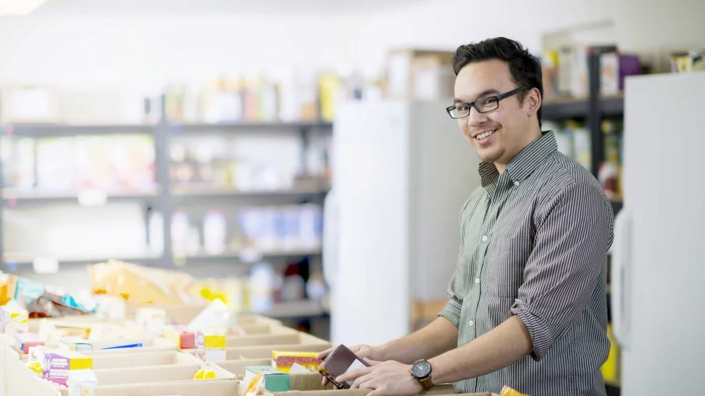 Decision Science | Arts & Culture Fundraising | Man volunteering at a food bank - slide